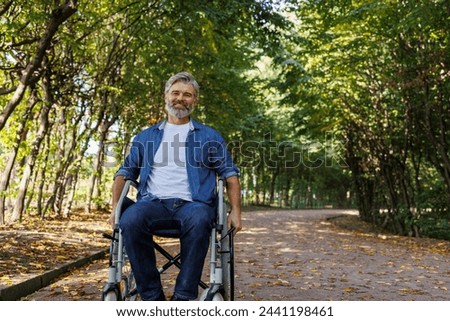 Similar – Image, Stock Photo Joyful wheelchair user with assistant enjoying outdoors