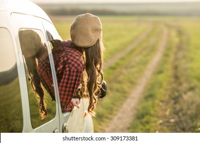Freedom car travel concept - woman relaxing out of window in a car. Road trip