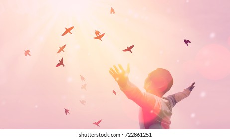 Freedom feel good and travel adventure concept. Copy space of silhouette man rising hands on sunset sky double exposure colorful bokeh and bird fly background. Vintage tone filter effect color style.  - Shutterstock ID 722861251