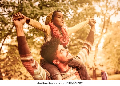 Freedom And Fresh Air Only For Us. Single African American Father With Daughter In Park Carrying On Shoulders.