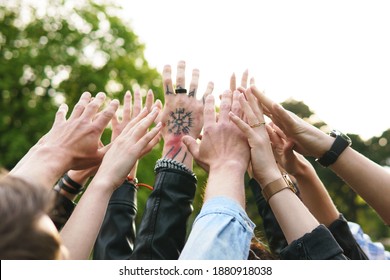 Freedom And Friendship. Group Of Young People Putting Hands Up In The Air.