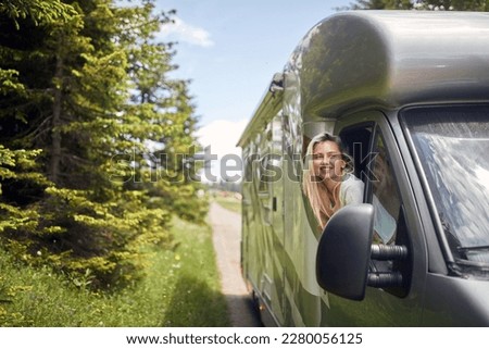 freedom journey travel with off road.Smiling girl on  vacation travel RV, holiday trip