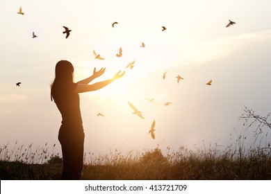 Freedom of life, free bird and woman enjoying nature on sunset background, freedom concept - Shutterstock ID 413721709