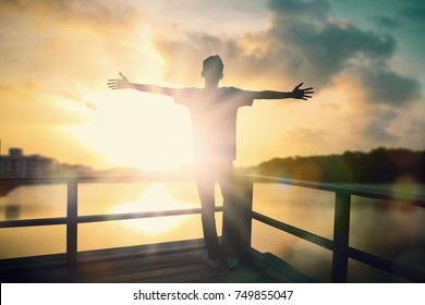 Freedom Man With Inspiration Rise Hands Up And Worship God In The Morning Sun Background. Now Christian Praise Jesus Reborn In Easter Day Concept For Wisdom Life, Hope Faith Love