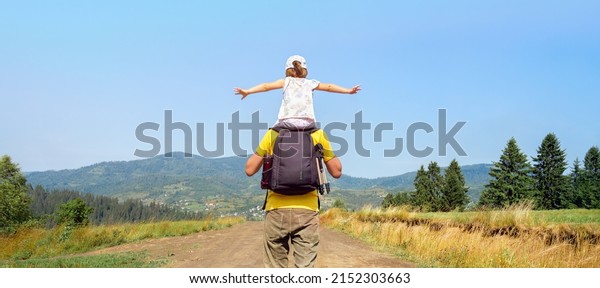 Freedom mountain children hiking trail walking hills.\
Piggyback ride father child travel mountain kids freedom child on\
shoulders dad and daughter father walking hiking trip nature kid\
arms spread out