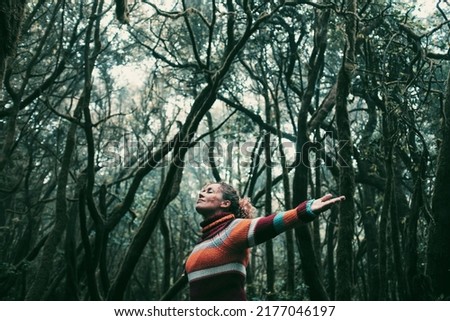 Freedom people enjoyng feeling with nature forest. Woman outstretching arms in the green woods. Leisure and ptrees protection. Earth's day and life scenic place. Tourist in travel amazing destination