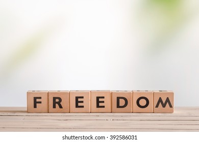 Freedom sign on a table in bright environment - Shutterstock ID 392586031