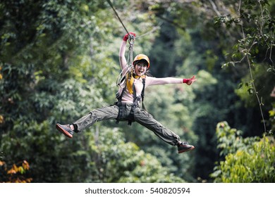 Freedom Woman Tourist Wearing Casual Clothing On Zip Line Or Canopy Experience In Laos Rainforest, Asia - Shutterstock ID 540820594