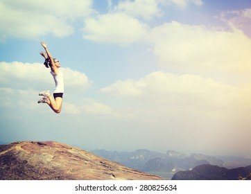 Freedom Young Asian Woman Jumping On Mountain Peak Rock 