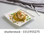 Freekeh with Chicken Isolated with Yogurt Styled and Garnished on a White Plate
