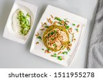 Freekeh with Chicken Isolated with Yogurt Styled and Garnished on a White Plate