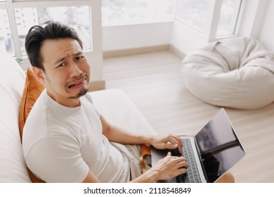Freelance Asian Man Sad With The Result In His Laptop.