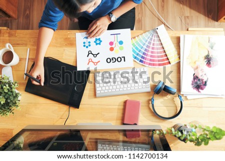 Freelance designer using graphics tablet when creating logotype
