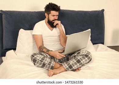 Freelance Job. Stay In Bed And Keep Working. Freelance Benefits. Man Surfing Internet Or Working Online. Hipster Bearded Guy Pajamas Freelance Worker. Remote Work Concept. Online Search Job Position.