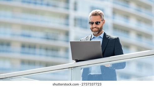 Freelance man working online. Freelance working online. Man using laptop for freelancing. Business freelancing. Man checking email outdoor. Communication online. Man with laptop banner