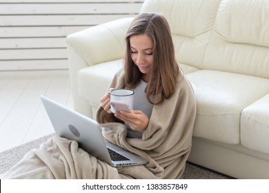 Freelance and people concept - Young woman sitting on floor and working at laptop - Shutterstock ID 1383857849