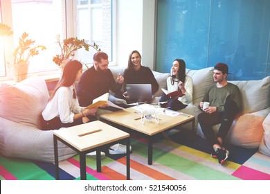 Freelance team members working together on making  researching about modern technology drone . Students share opinions during break sitting in coworking space inspiring by conversation with friends - Powered by Shutterstock