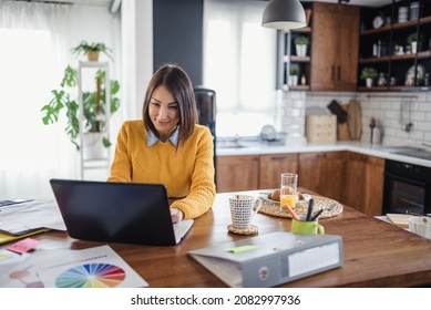 Freelance Woman Working In Home Office With Laptop Computer. Flexible Workspace And Working Time.