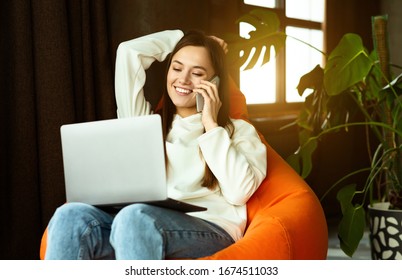 Freelance Work From Anywhere. Girl Communicates On Smartphone In Bag Chair, Sun Flare