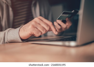 Freelance Worker Using E-banking Service, Making Online Payment With Debit Card And Laptop Computer, Close Up With Selective Focus