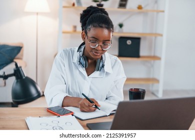 Freelance Worker. Young African American Woman In White Shirt Is At Home.