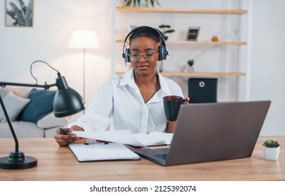 Freelance Worker. Young African American Woman In White Shirt Is At Home.