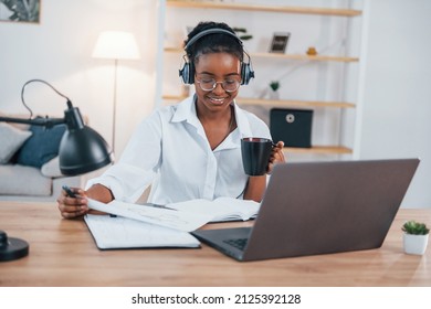 Freelance Worker. Young African American Woman In White Shirt Is At Home.