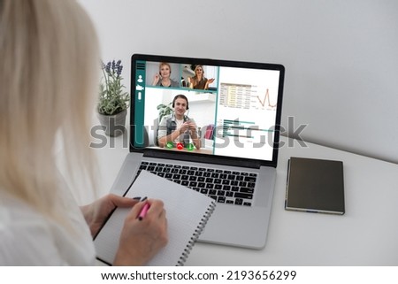 Freelancer, distant working, elearning concept. Young smiling pretty woman worker sitting and looking at laptop screen during videocall, online lecture. Distant learning, connection