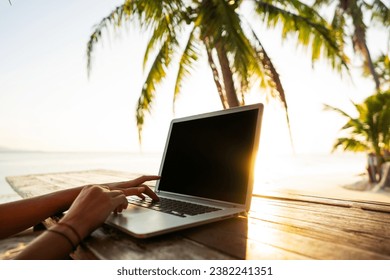 
Freelancer girl with a computer among tropical palm trees work on the island in sunset - Powered by Shutterstock