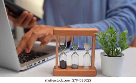 A freelancer juggles multiple devices while racing against hourglasses, symbolizing time management, productivity, stress, adaptability, and the challenge of meeting deadlines in a fast-paced world.

