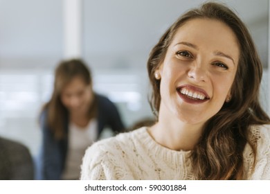 Freelancer In The Office Looking At The Camera Smiling