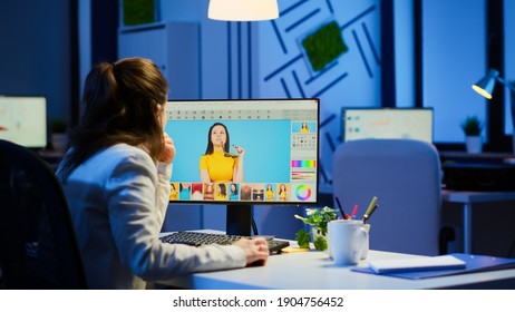 Freelancer retoucher woman working overtime on laptop computer with photo editing software. Professional graphic editor retouching photos of a client during night time in home office on performance pc