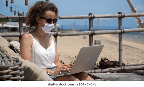 Freelancer Woman Sitting On Sofa Near Ocean And Working On Laptop In Musk. 4K