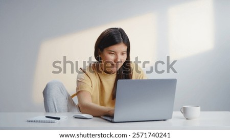 Freelancer woman work using computer laptop sit at home. Joy busy girl type e mail wear yellow t shirt. Remote education during covid 19 corona virus. Distance job start up. Online internet shopping.