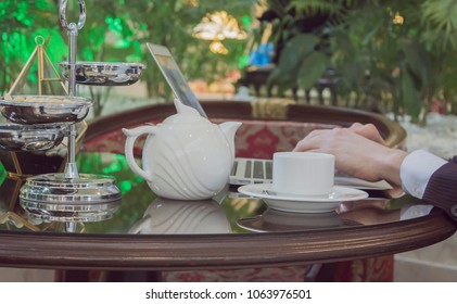 freelancer works at computer table coffee