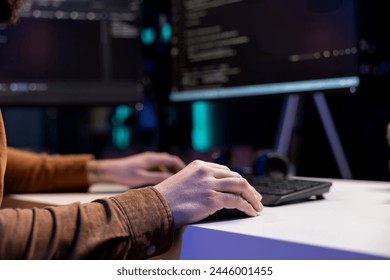 Freelancing cybersecurity admin using computer to look for company security vulnerabilities. IT engineer typing on keyboard, installing fortified code on PC to prevent cyber attacks, close up
