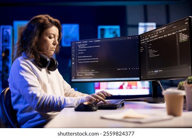 Freelancing professional working from home developing software in Java programming language using PC. Software technician in apartment writing lines of code on computer using keyboard
