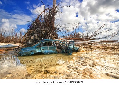 Freeport, Grand Bahama Island, Bahamas - October 11 2019 : Huge tree trunk on top of a vehicle. Eastern part of the Grand Bahama Island where most of the devastation occurred from Hurricane Dorian. 