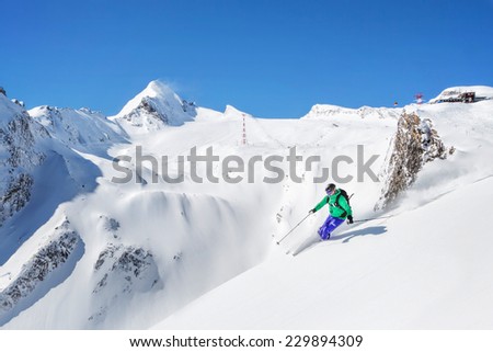 Freeride skiier in the mountains