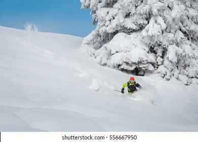 Freeride Skiier Riding In Deep Powder Snow