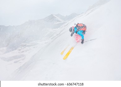 Freeride Skiier Riding In Deep Powder Snow