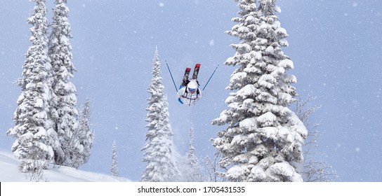 A Freerider In Bright Gear Jumps Between Christmas Trees With A Backflip Element. Prof Skier In A Beautiful Flight At High Altitude. Winter Fun At The Ski Resort. Good Powder Day. Funny Skiing