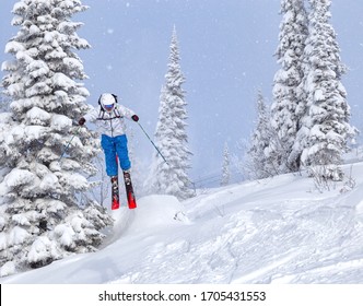 A Freerider In Bright Gear Jumps Between Christmas Trees With A Backflip Element. Prof Skier In A Beautiful Flight At High Altitude. Winter Fun At The Ski Resort. Good Powder Day. Funny Skiing