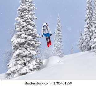 A Freerider In Bright Gear Jumps Between Christmas Trees With A Backflip Element. Prof Skier In A Beautiful Flight At High Altitude. Winter Fun At The Ski Resort. Good Powder Day. Funny Skiing