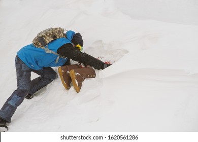 Freerider Digging Snow Avalanche To Safe A Person Buried By An Avalanche. Danger Extreme Concept