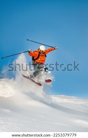 Free-rider skier jumps and has fun in powder snow