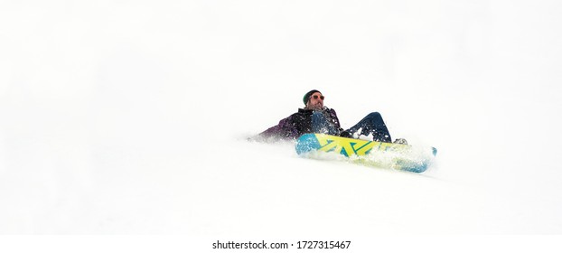 Freerider Snowboarder Drop Fall Down And Crash With His Snowboard On Extreme Gradient Downhill. Winter Mountain Freeride. Space Place For Text