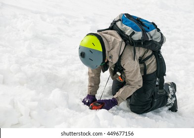 Freerider Using An Avalanche Beacon To Find A Person Buried By An Avalanche 