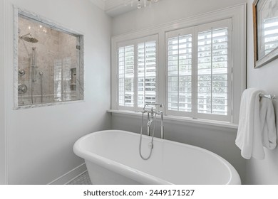 Freestanding Bathtub by Large Windows with Plantation Shutters, Glass Shower View