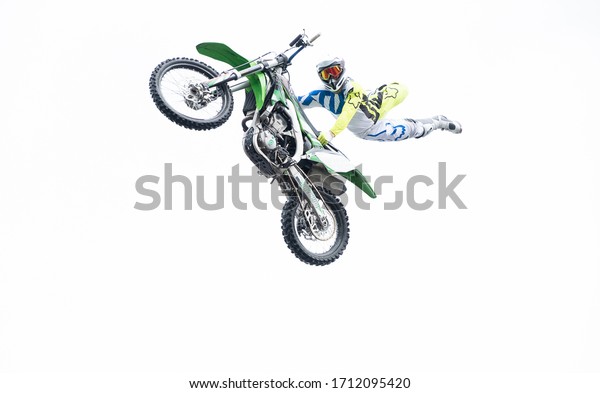 the freestyle\
motocross. Biker stunt rider doing a jump and perfom acrobatic\
stunt flying. fmx\
motocycles